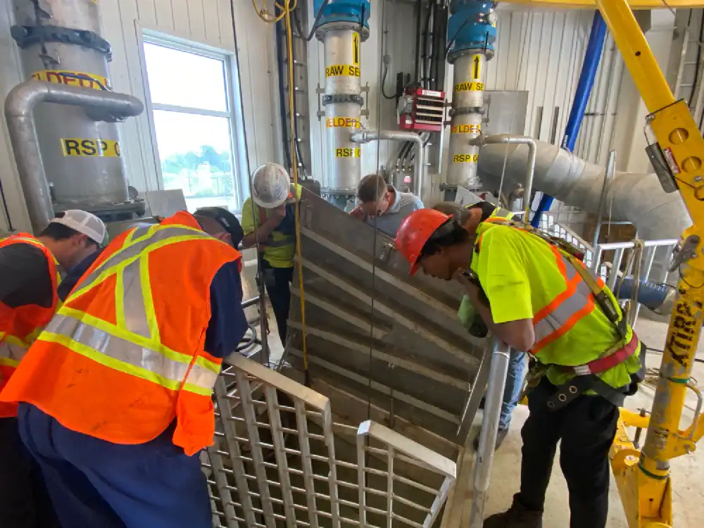 Group of people inspecting a pumping station